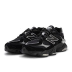 Black New Balance sneakers on a white background